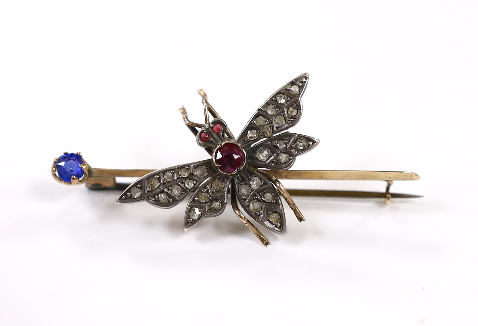 A Victorian yellow metal, rose cut diamond, ruby and blue stone doublet set bug bar brooch, 54mm, gross weight 7.3 grams.